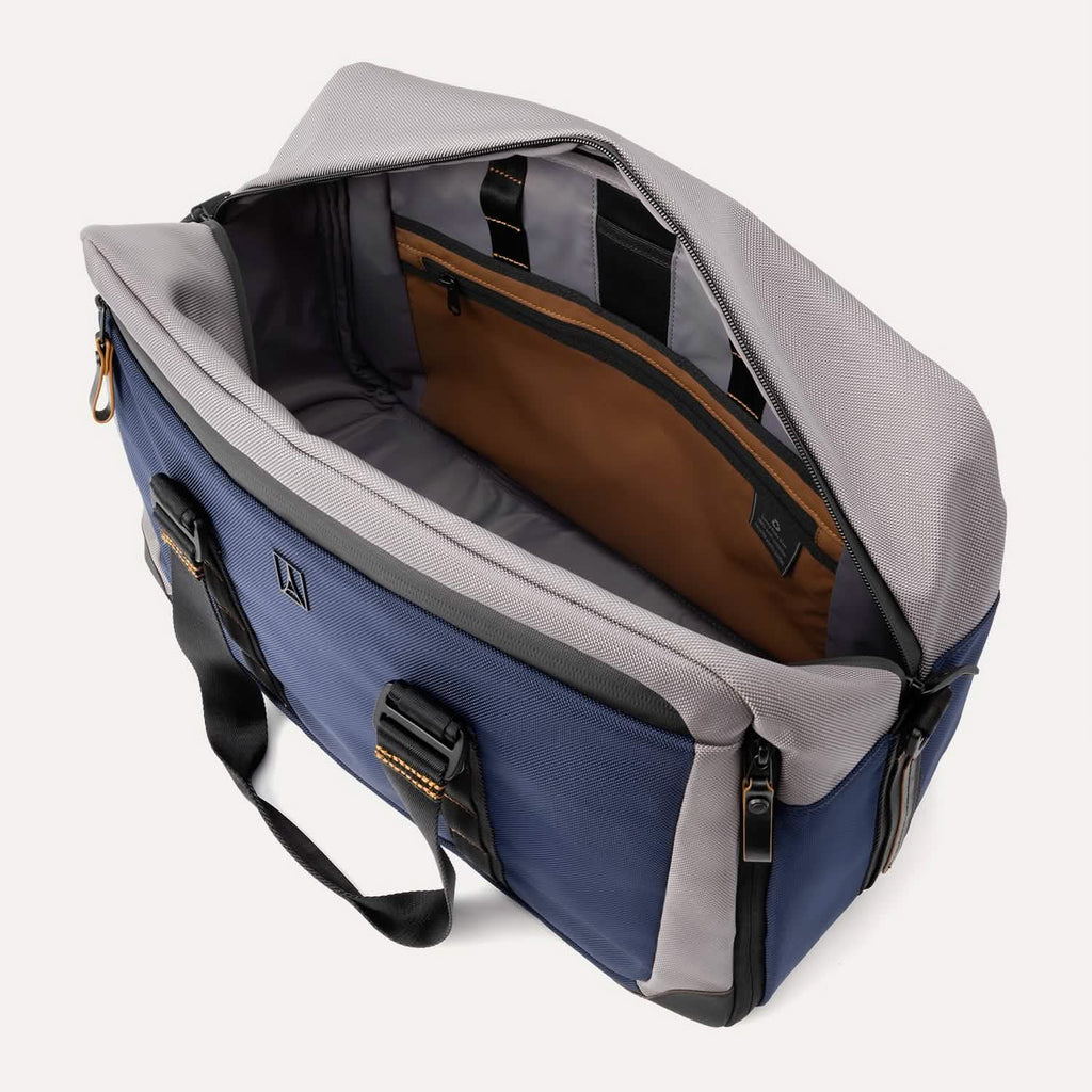 Open top view of the Travelpro® Altitude™ Double Expansion Duffel in Stellar Navy/Grey, showing a spacious main compartment with an interior zippered pocket, organizational sleeves, and contrast lining.
