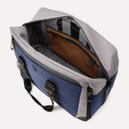 Open top view of the Travelpro® Altitude™ Double Expansion Duffel in Stellar Navy/Grey, showing a spacious main compartment with an interior zippered pocket, organizational sleeves, and contrast lining.
