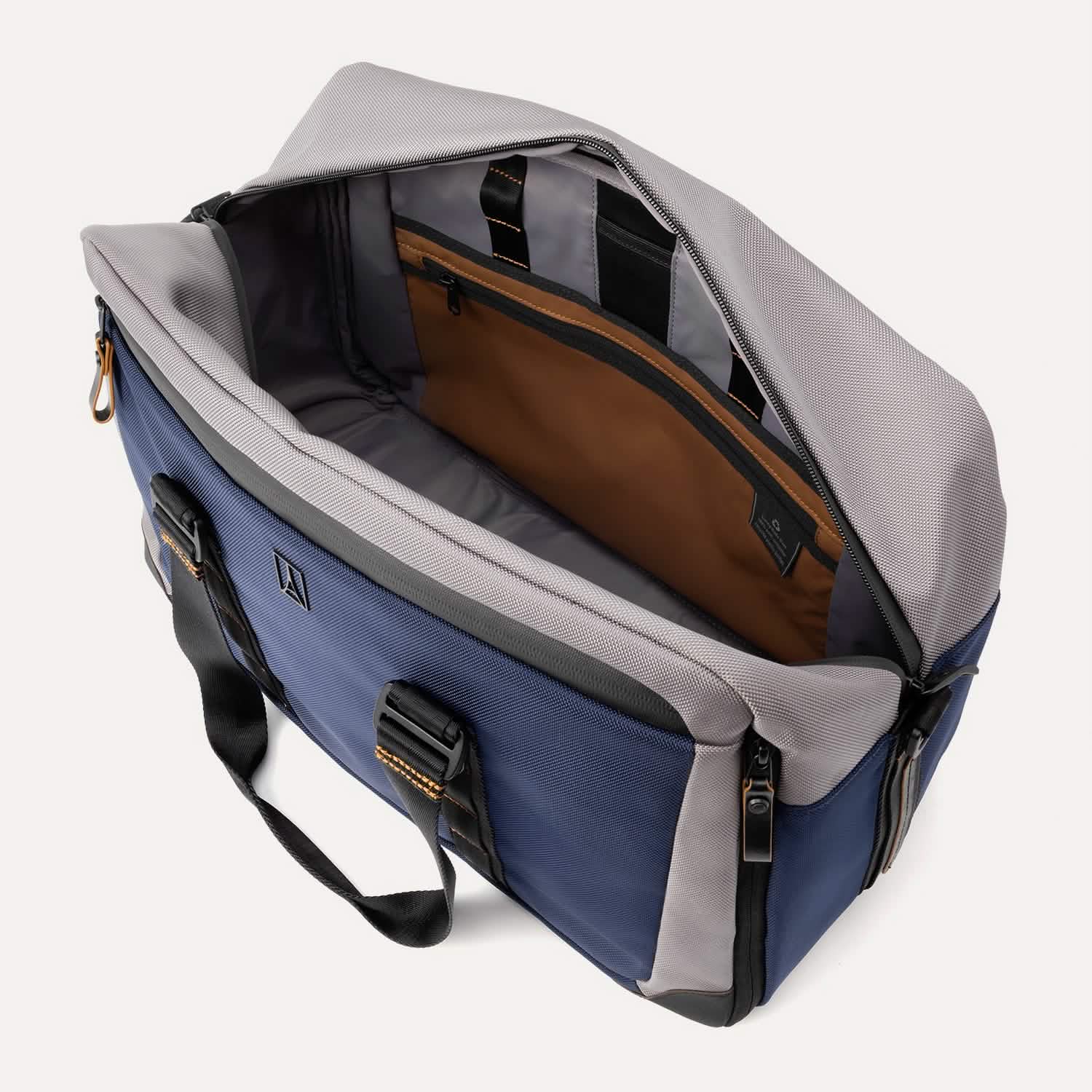 Open top view of the Travelpro® Altitude™ Double Expansion Duffel in Stellar Navy/Grey, showing a spacious main compartment with an interior zippered pocket, organizational sleeves, and contrast lining.
