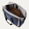 Open top view of the Travelpro® Altitude™ Double Expansion Duffel in Stellar Navy/Grey, showing a spacious main compartment with an interior zippered pocket, organizational sleeves, and contrast lining.

