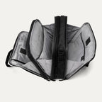Open view of the Travelpro® Altitude™ Full Expansion Brief in black, showing three spacious compartments with divider panels and organizational sleeves.
