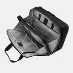 Open view of the Travelpro® Altitude™ Full Expansion Brief in black, showing three spacious compartments with divider panels and organizational sleeves for efficient packing and document storage.
