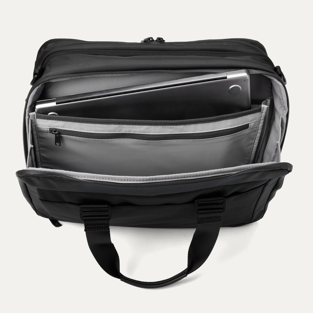 Top view of the rear compartment of the Travelpro® Altitude™ Full Expansion Brief in black, open to reveal a padded laptop sleeve, a zippered pocket, and multiple organizational slots for documents and accessories.
