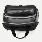 Top view of the rear compartment of the Travelpro® Altitude™ Full Expansion Brief in black, open to reveal a padded laptop sleeve, a zippered pocket, and multiple organizational slots for documents and accessories.
