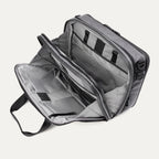 Open main compartment view of the Travelpro® Altitude™ Full Expansion Brief in Falcon Grey, showing dual sections with organizational pockets, zippered storage, and ample packing space.

