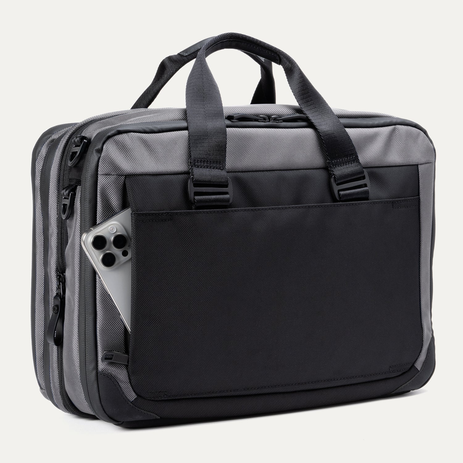 Rear view of the Travelpro® Altitude™ Full Expansion Brief in Falcon Grey, featuring a large exterior pocket holding a smartphone and dual top handles.
