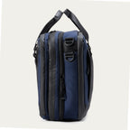 Side view of the Travelpro® Altitude™ Full Expansion Brief in Aviator Navy, highlighting its dual zippered compartments and attachment points for a shoulder strap.
