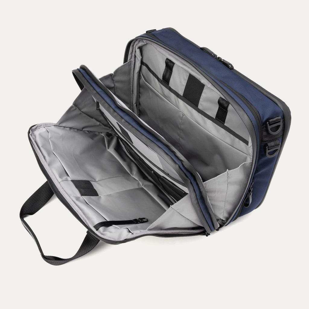 Travelpro® Altitude™ Full Expansion Brief in Aviator Navy, open interior view showing its organized compartments, zippered pockets, and padded sections for secure storage.

