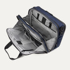 Travelpro® Altitude™ Full Expansion Brief in Aviator Navy, open interior view showing its organized compartments, zippered pockets, and padded sections for secure storage.

