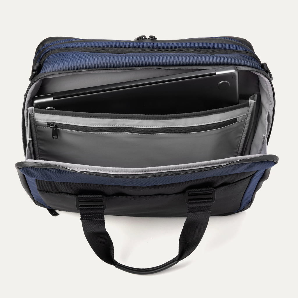 Top view of the Travelpro® Altitude™ Full Expansion Brief in Aviator Navy showing the rear compartment open, with a padded laptop sleeve and additional zippered and slip pockets for organized storage.