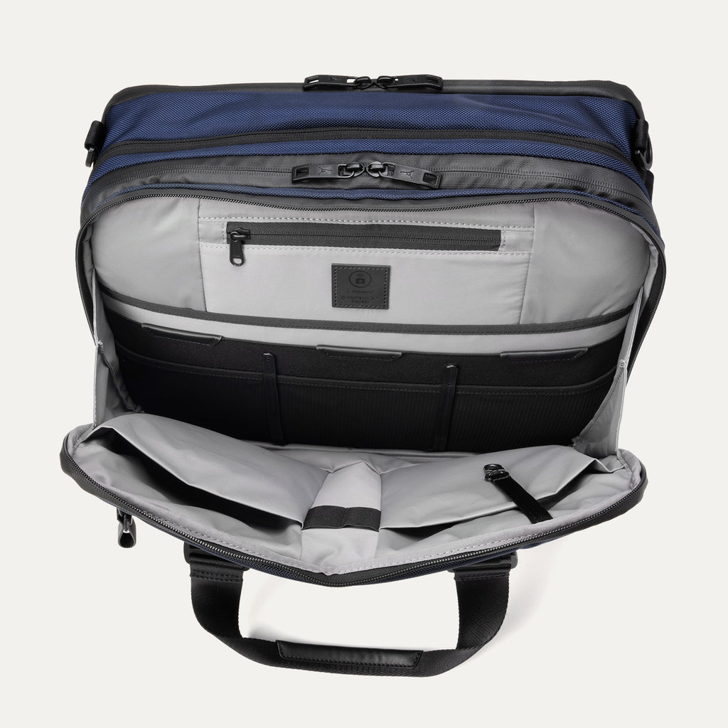Open front pocket view of the Travelpro® Altitude™ Full Expansion Brief in Aviator Navy, showing an organized interior with a zippered pocket and multiple divided compartments for accessories.
