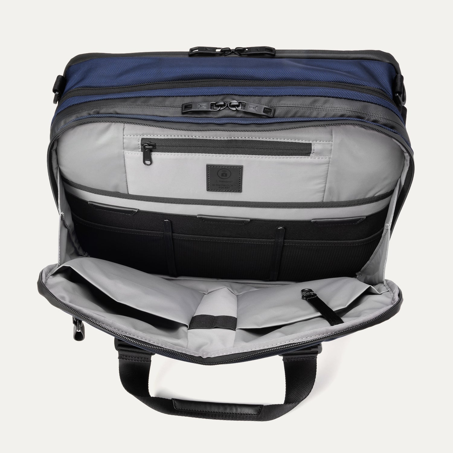 Open front pocket view of the Travelpro® Altitude™ Full Expansion Brief in Aviator Navy, showing an organized interior with a zippered pocket and multiple divided compartments for accessories.
