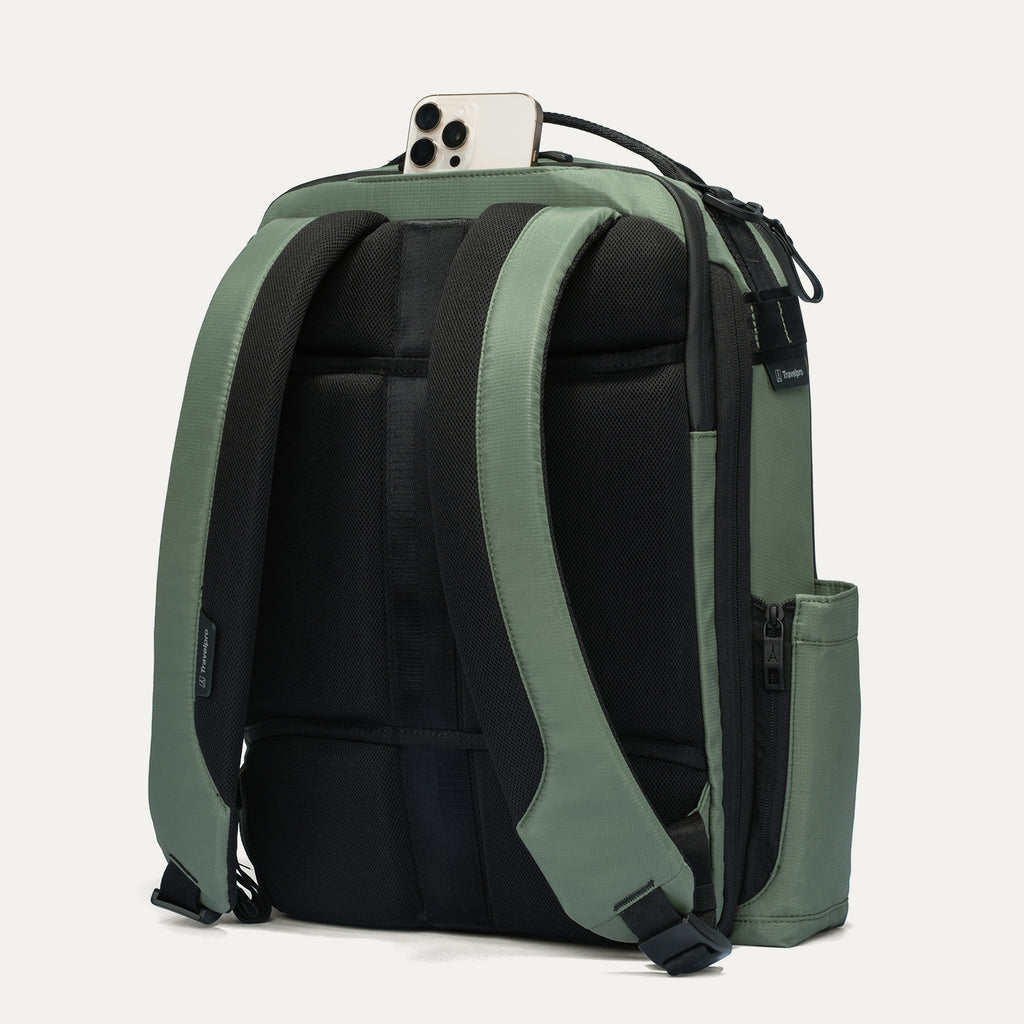 Green and black backpack with a phone on top against a white background