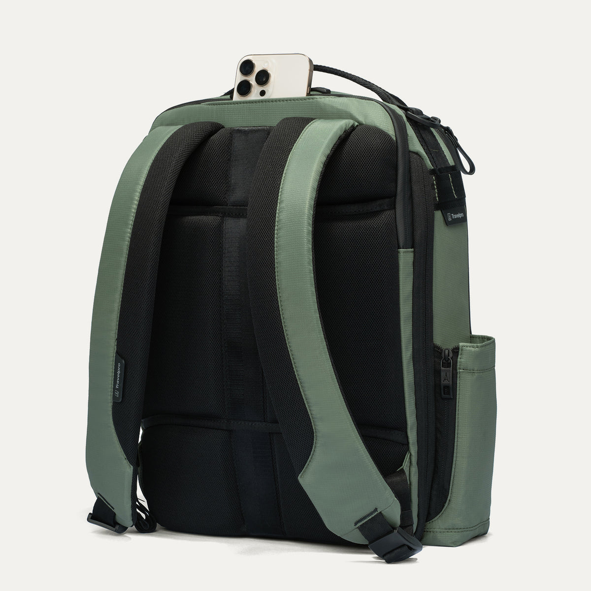 Green and black backpack with a phone on top against a white background