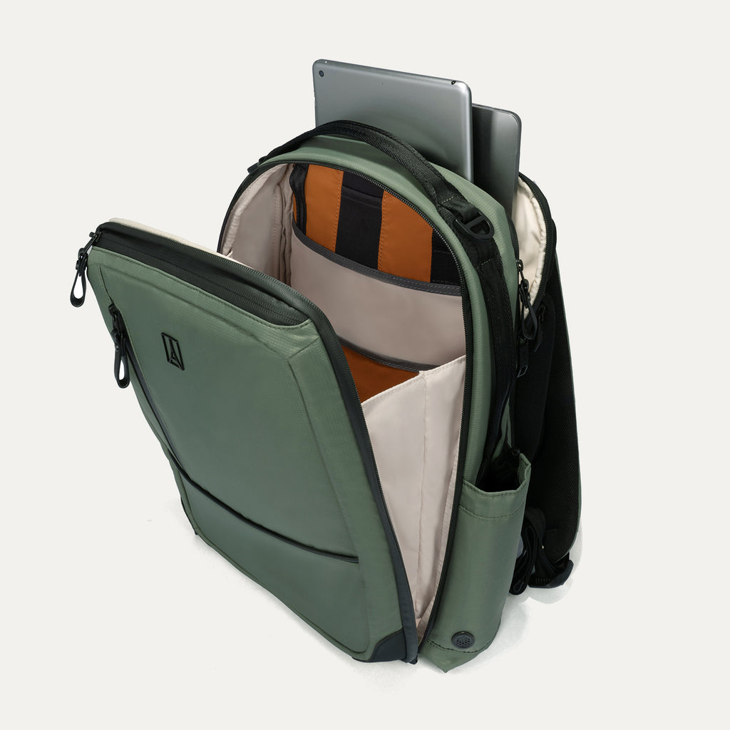 Green backpack with open compartment showing a laptop and orange interior.