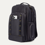 Three‑quarter front view of the Travelpro Altitude Large Backpack in Neon Shadow, showing black textured exterior with neon yellow stitching accents, multiple zippered compartments, and an Phone in the front pocket against a light background.