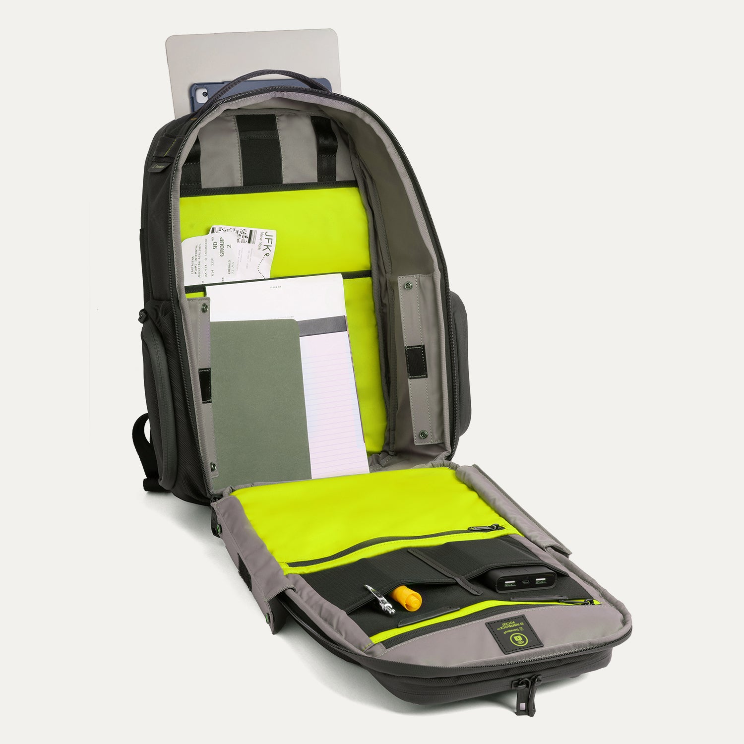 Front view of the Travelpro Altitude Large Backpack in Neon Shadow, showing fully open main compartment with laptop sleeve, organization pockets, and bright neon yellow interior panels against a light background.