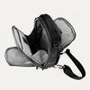 Interior view of Travelpro Altitude Crossbody 6L in Black, showing dual compartments with gray lining and tablet sleeve.
