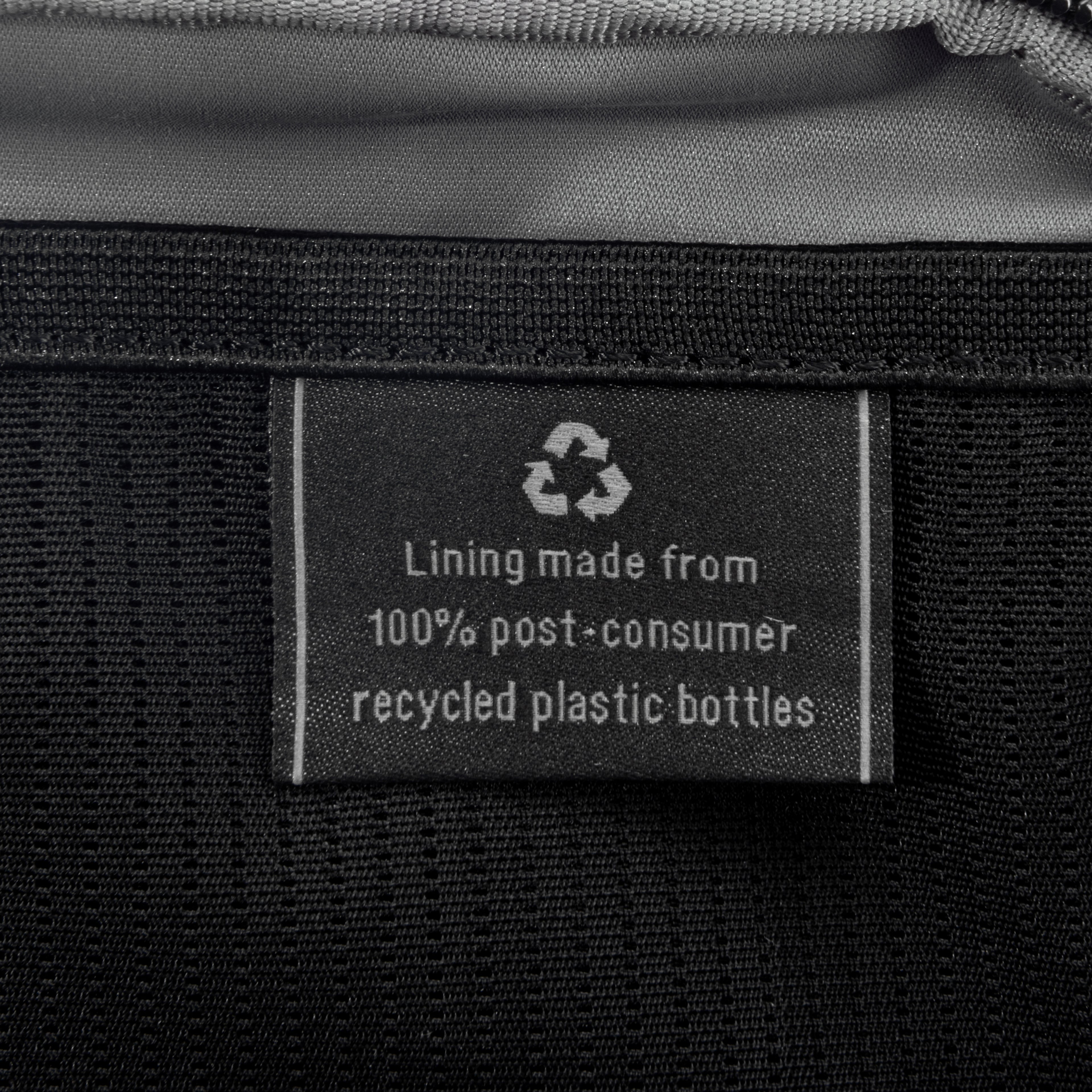 Close-up of interior tag showing that the lining is made from 100% post-consumer recycled plastic bottles.
