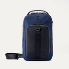 Front view of Travelpro Altitude Crossbody 6L in Aviator Navy, featuring exterior pocket with daisy chain and top carry handle.
