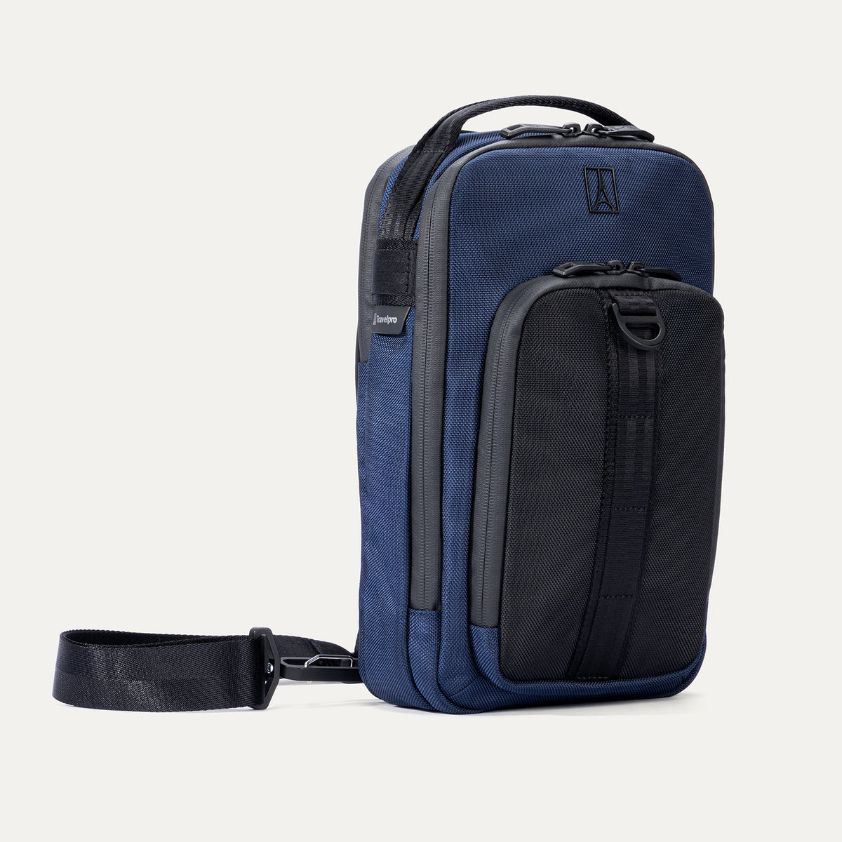 Angled front view of Travelpro Altitude Crossbody 6L in Aviator Navy, featuring exterior zip pocket with daisy chain.
