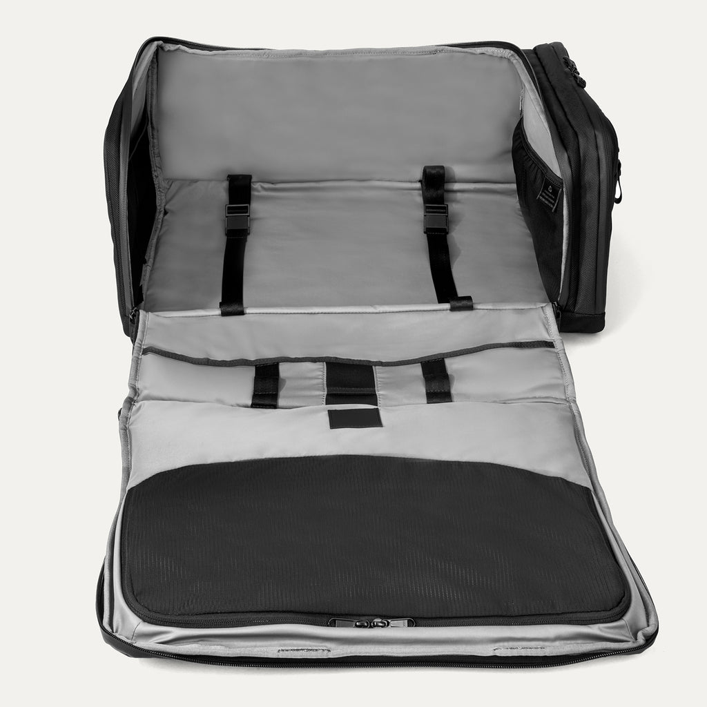Open backpack with gray interior and black exterior on a white background