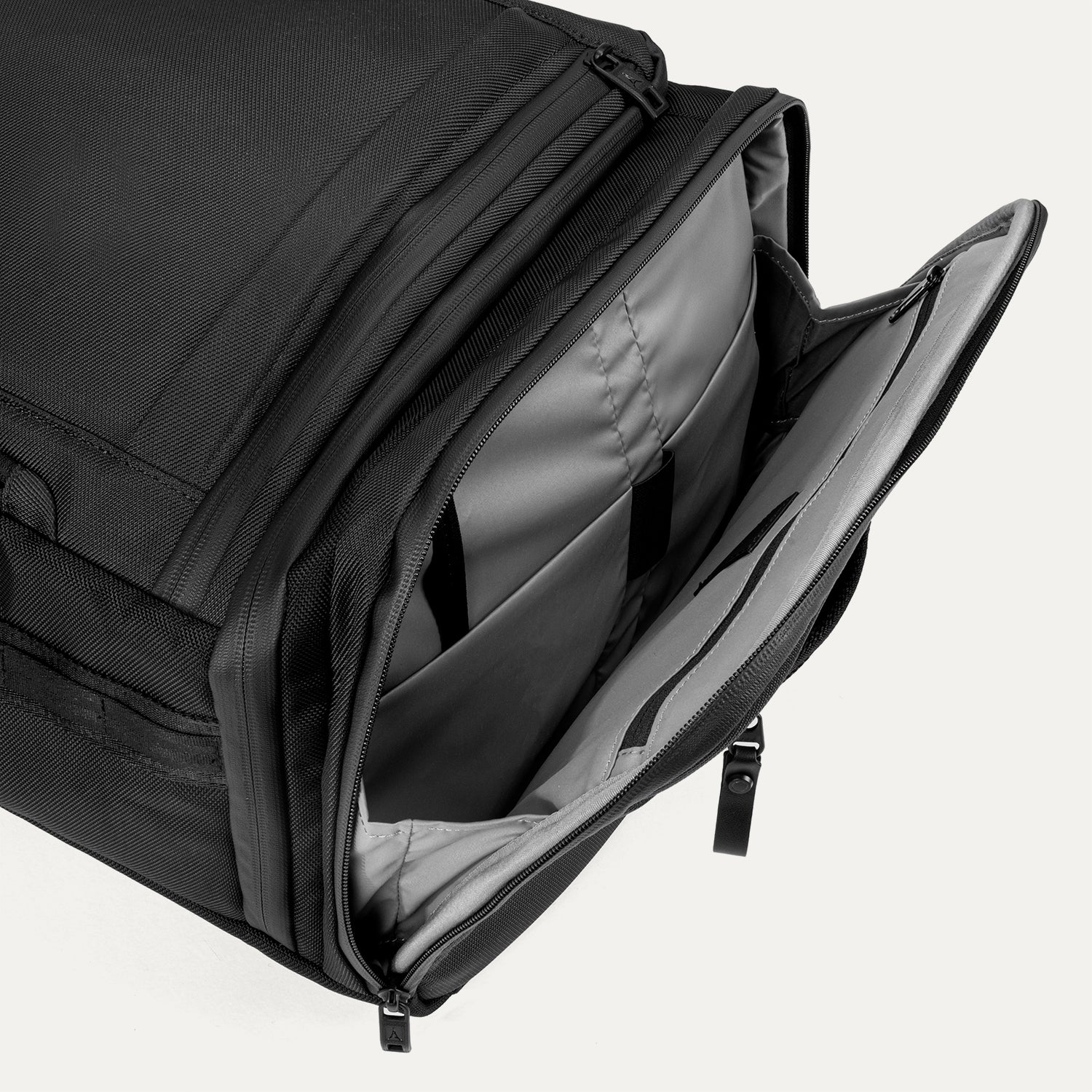 Open side compartment of the Travelpro Altitude Convertible Duffel/Backpack in Jet Black, revealing interior storage for accessories or gear.

