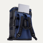 Back view of the Travelpro Convertible Duffel/Backpack in Aviator Navy, featuring padded backpack straps and rear laptop pocket with laptop partially inserted.
