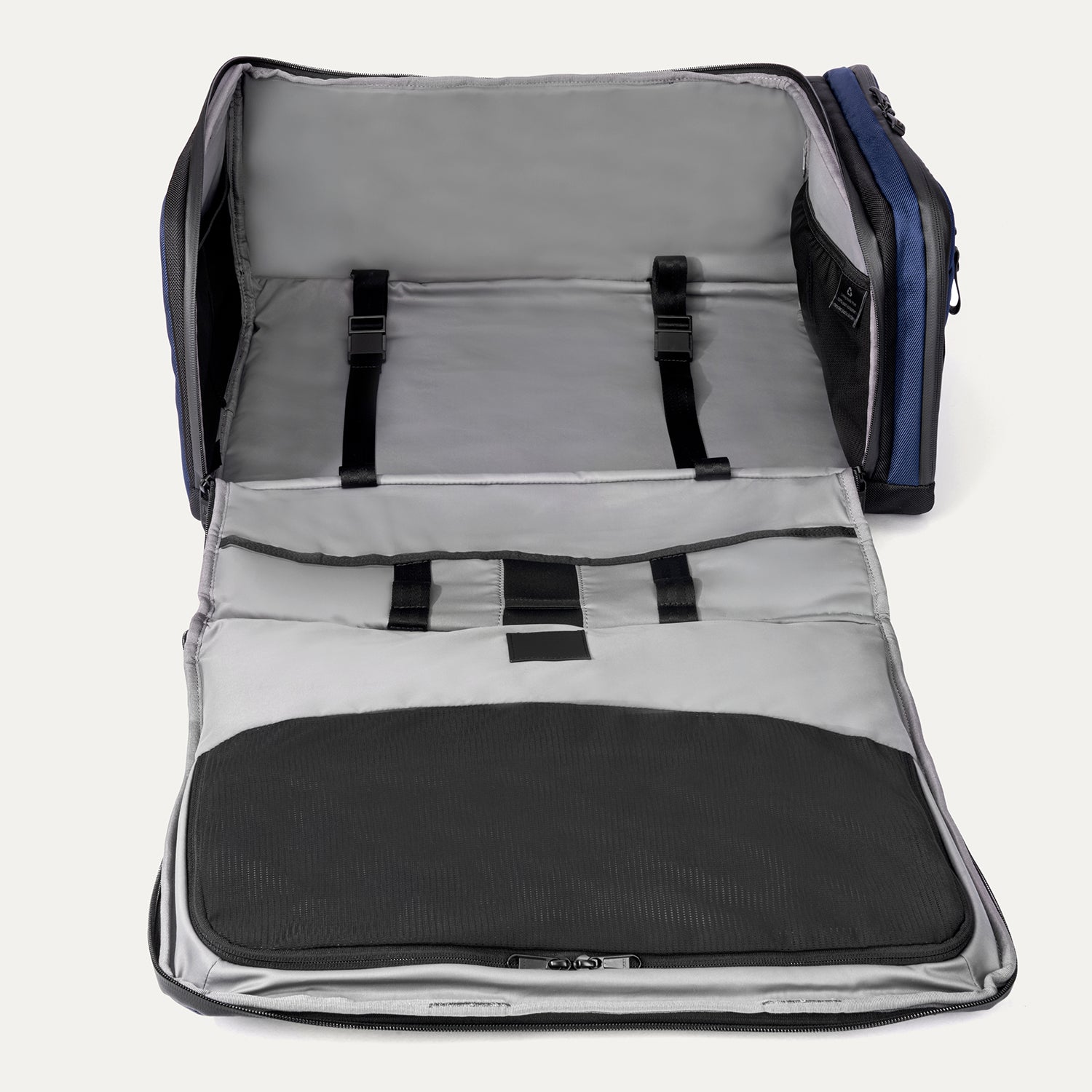 Interior view of the Travelpro Altitude Convertible Duffel/Backpack in Aviator Navy, with mesh divider and adjustable hold-down straps.

