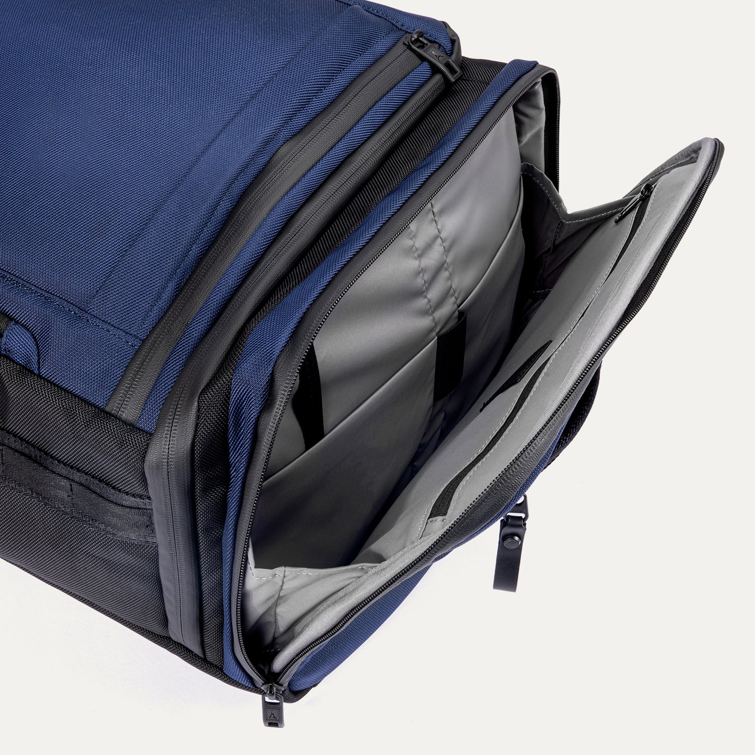 Side pocket view of the Travelpro Altitude Convertible Duffel/Backpack in Aviator Navy, showing open compartment with organizer sleeves.
