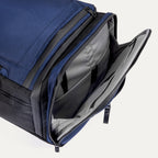 Side pocket view of the Travelpro Altitude Convertible Duffel/Backpack in Aviator Navy, showing open compartment with organizer sleeves.
