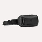 Travelpro Altitude Sling 2L in Jet Black, showing front zip pocket and adjustable strap with Travelpro tag.


