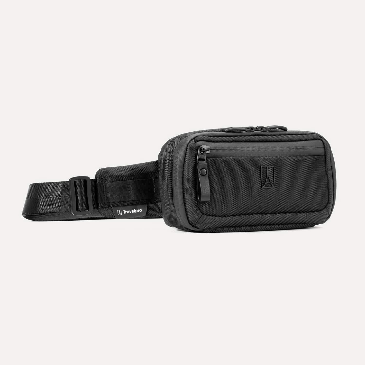Travelpro Altitude Sling 2L in Jet Black, showing front zip pocket and adjustable strap with Travelpro tag.

