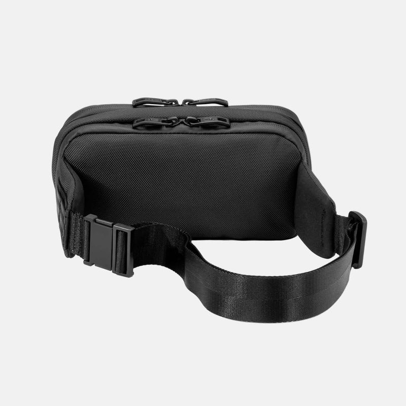 Rear view of Travelpro Altitude Sling 2L in Jet Black, showing adjustable strap and smooth back panel.
