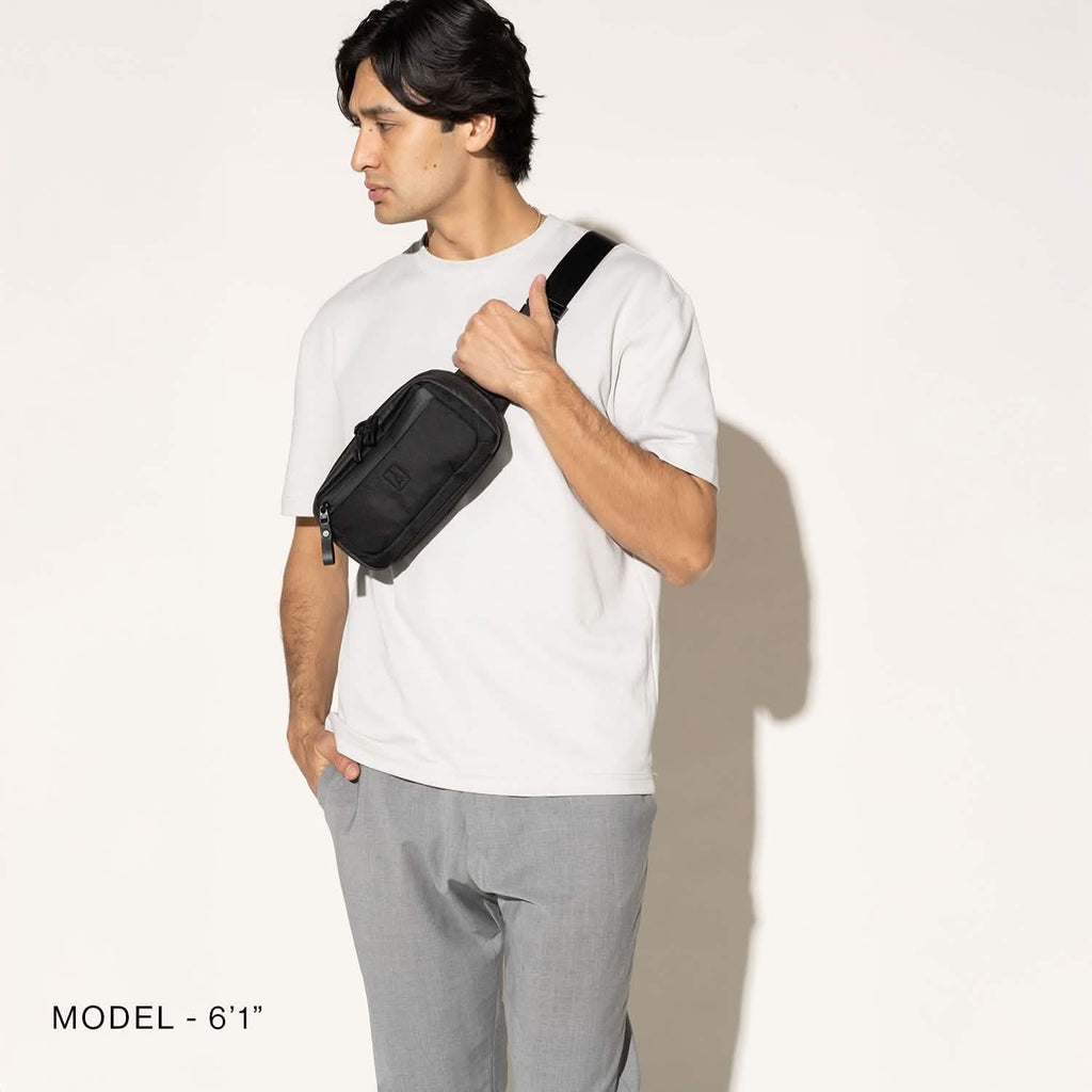 Person wearing a black sling over the shoulder on a white background