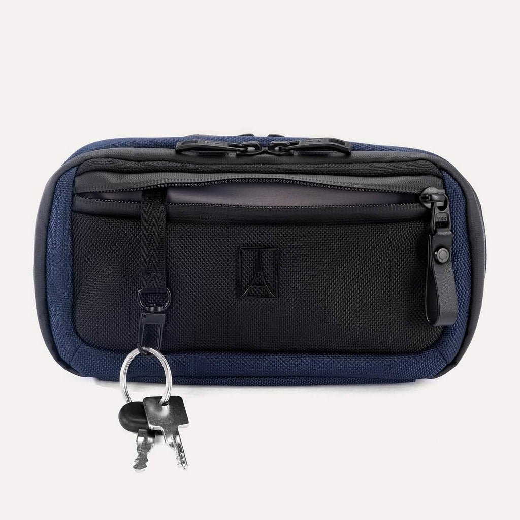 Travelpro Altitude Sling 2L in Aviator Navy, front view with key leash attached and zippered pocket visible.
