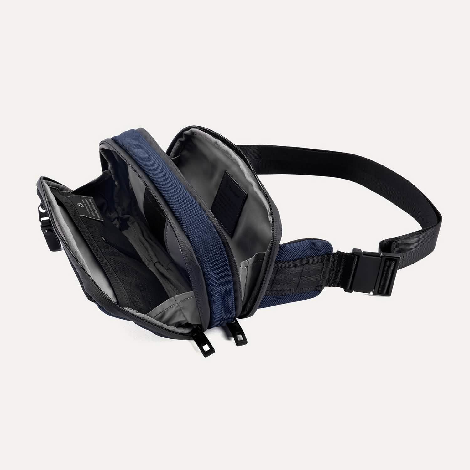 Travelpro Altitude Sling 2L in Aviator Navy, interior view with mesh organizer and multiple compartments fully unzipped.
