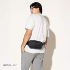 Person wearing a aviator navy sling around the waist on a white background