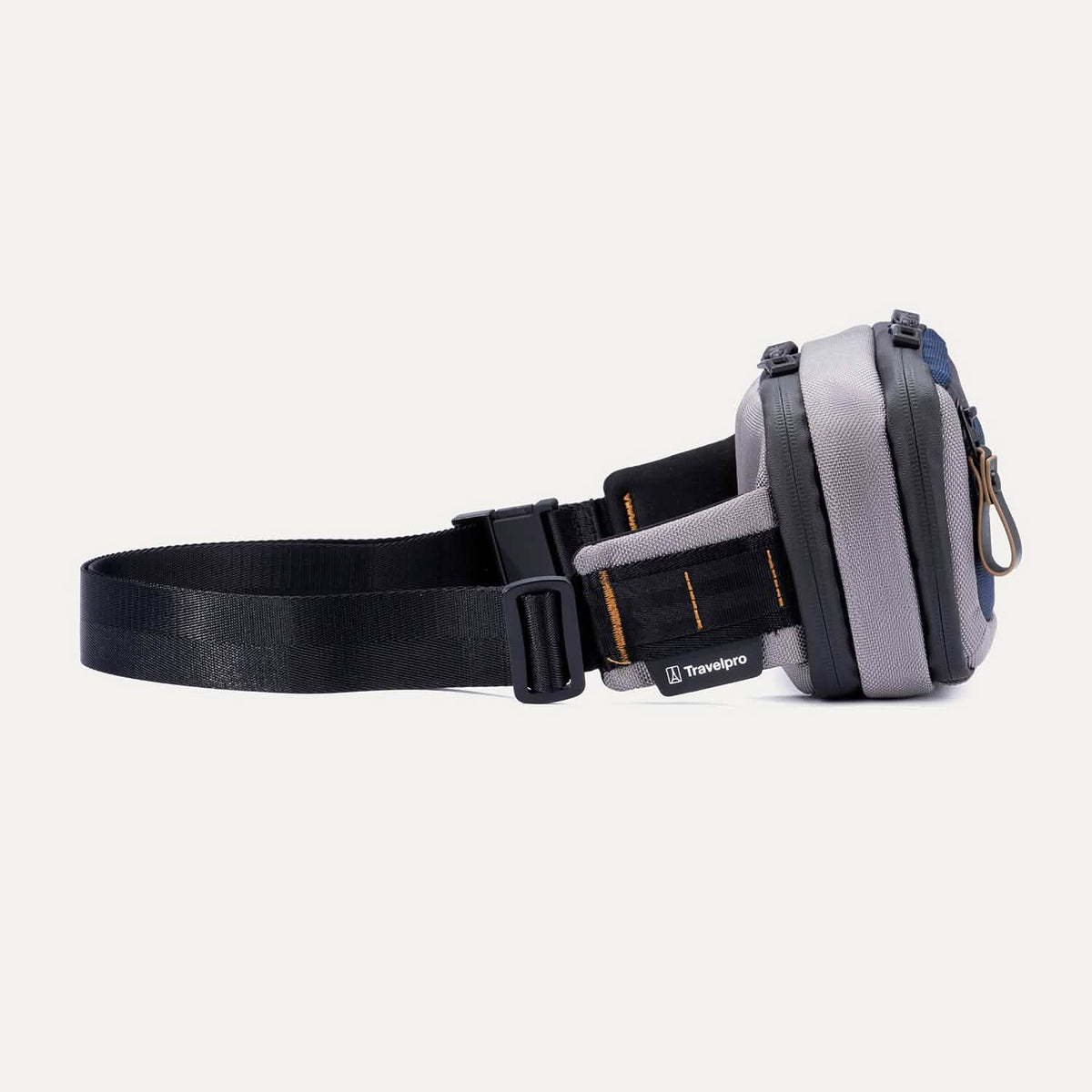Side view of the Travelpro Altitude Sling 2L in Stellar Navy/Grey, showing the buckle closure and stitched brand tag.
