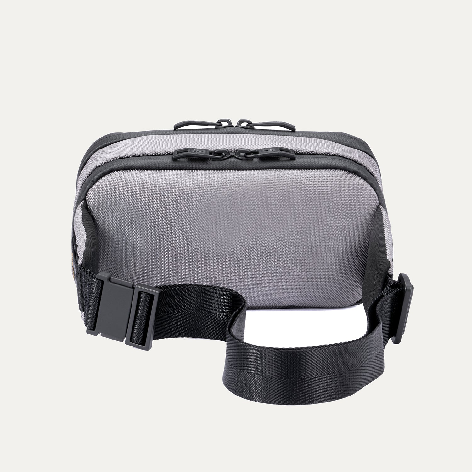 Rear view of the Travelpro Altitude Sling 2L in Stellar Navy/Grey, showing the adjustable waist strap and back panel.