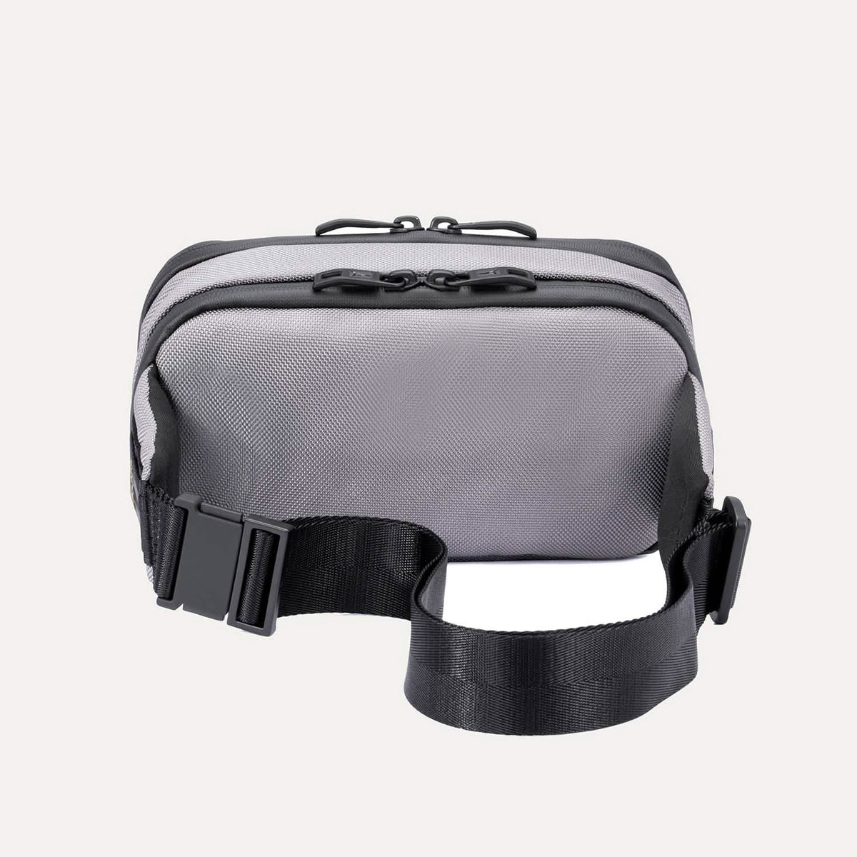 Rear view of the Travelpro Altitude Sling 2L in Stellar Navy/Grey, showing the adjustable waist strap and back panel.
