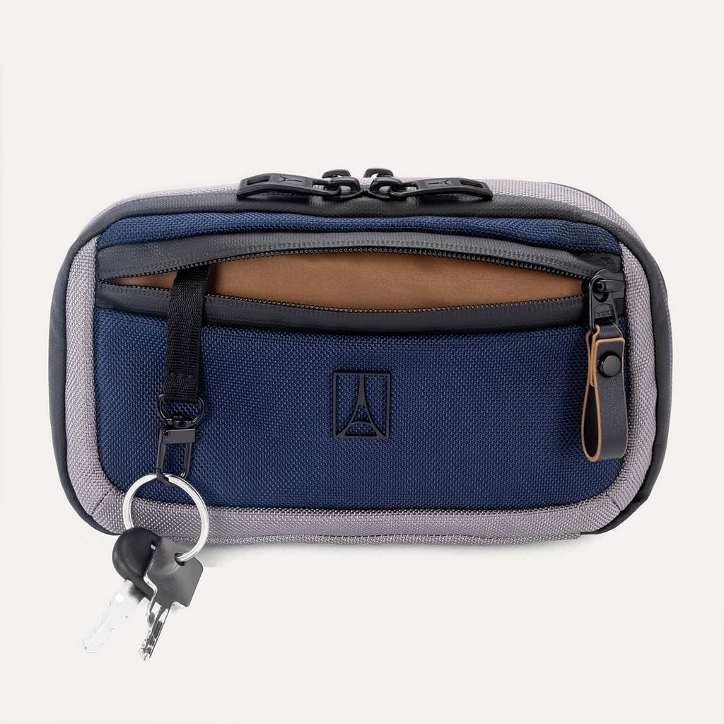 Front view of the Travelpro Altitude Sling 2L in Stellar Navy/Grey, featuring a front zip pocket and key leash
