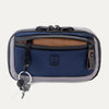 Front view of the Travelpro Altitude Sling 2L in Stellar Navy/Grey, featuring a front zip pocket and key leash
