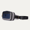 Travelpro Altitude Sling 2L in Stellar Navy/Grey, featuring front zippered pocket and adjustable buckle strap.

