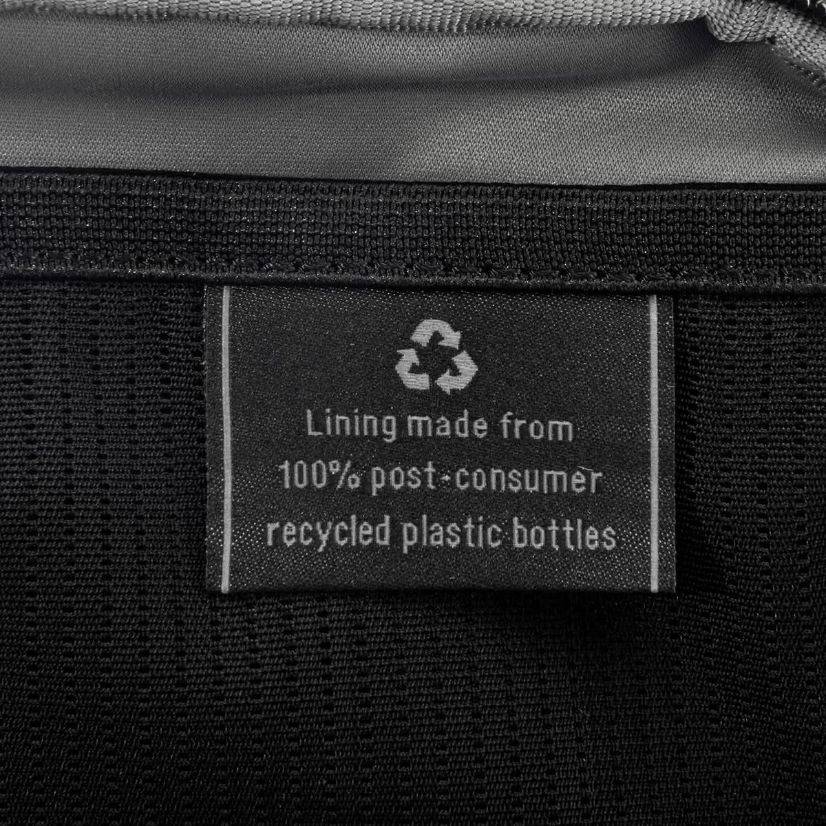 Close-up of interior tag showing that the lining is made from 100% post-consumer recycled plastic bottles.
