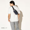 Person wearing a stellar navy sling over the shoulder on a white background