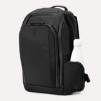 Front angle of Travelpro Altitude All-Purpose Laptop Backpack in Jet Black, showing exterior pocket with bottle storage.
