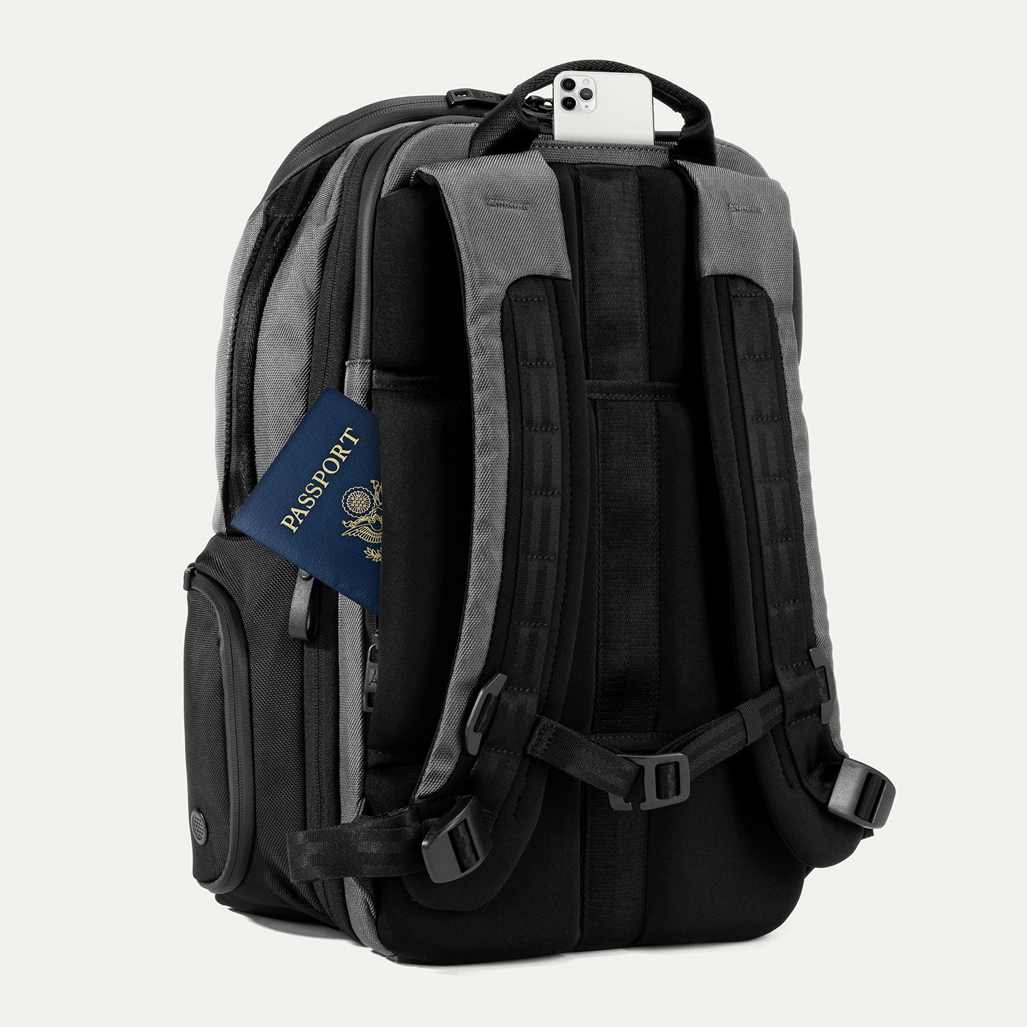 Rear view of Travelpro Altitude All-Purpose Laptop Backpack in Falcon Grey, showing padded straps and QuickSlip Pocket with phone and hidden pocket with passport.
