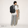Person wearing a falcon grey backpack on a white background