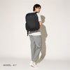Person wearing a aviator navy backpack on a white background